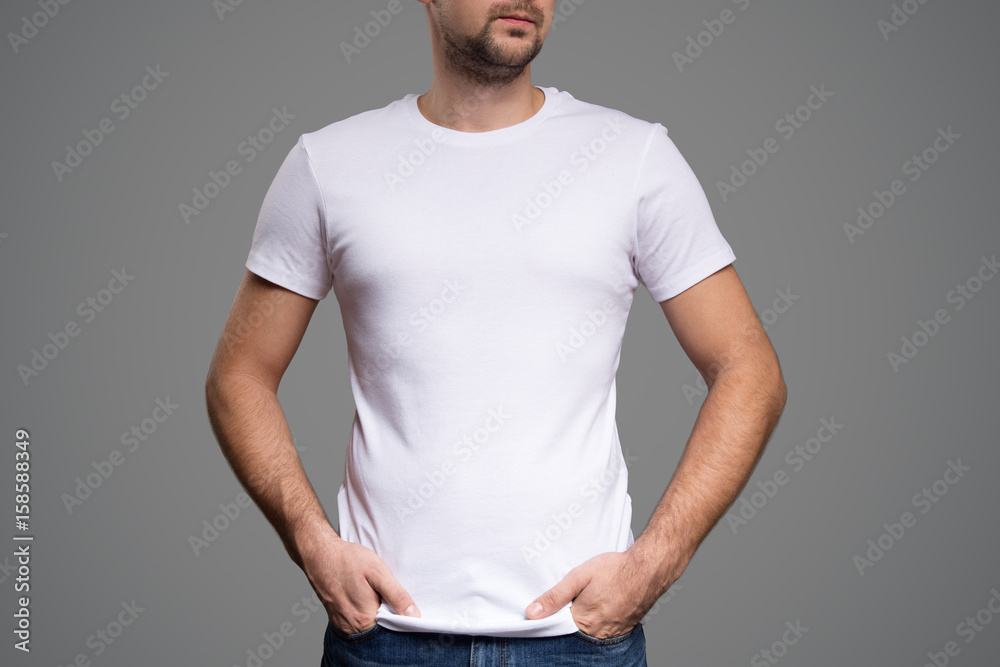 White t-shirt on a young man template. Gray background. White t-shirt on a young man template. Gray background.
