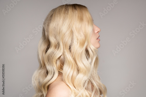 Portrait Of A Beautiful Young Blond Woman With Long Wavy Hair.