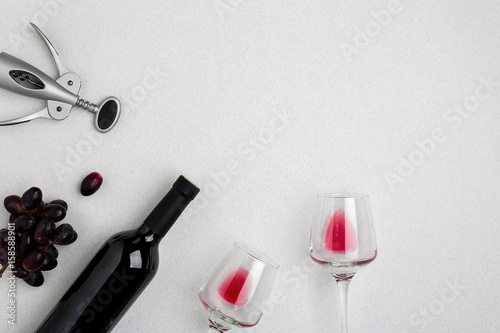 Bottle of red wine with glasses on white background top view mock-up