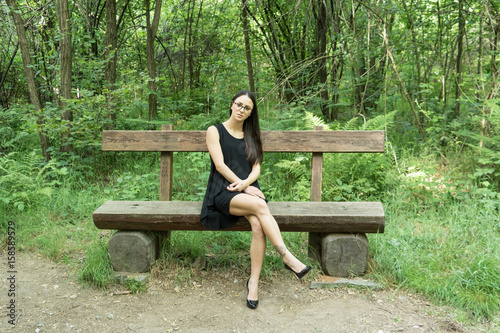 Young woman in evening dress in the woods