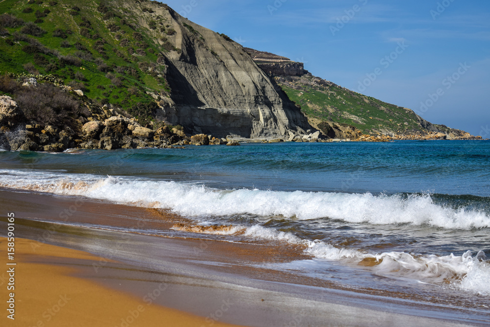 Waves washing the beach in Ramla bay close-up - Gozo, Malta Waves washing the beach in Ramla bay close-up - Gozo, Malta