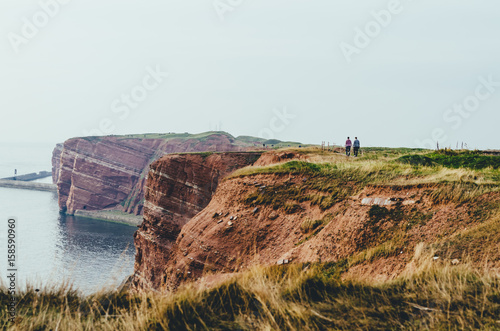 People walking on the cliffs of an island