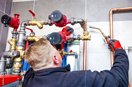 Photos Plumber assembles the boiler room