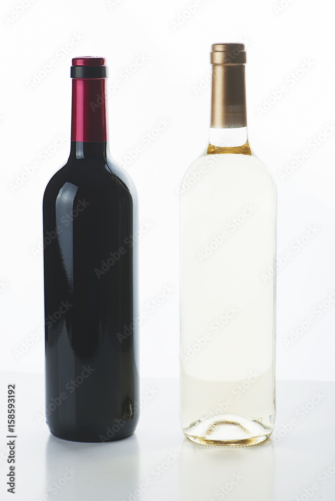 Vertical studio shot of two unlabeled bottles for red and white wine. Vertical studio shot of two unlabeled bottles for red and white wine.