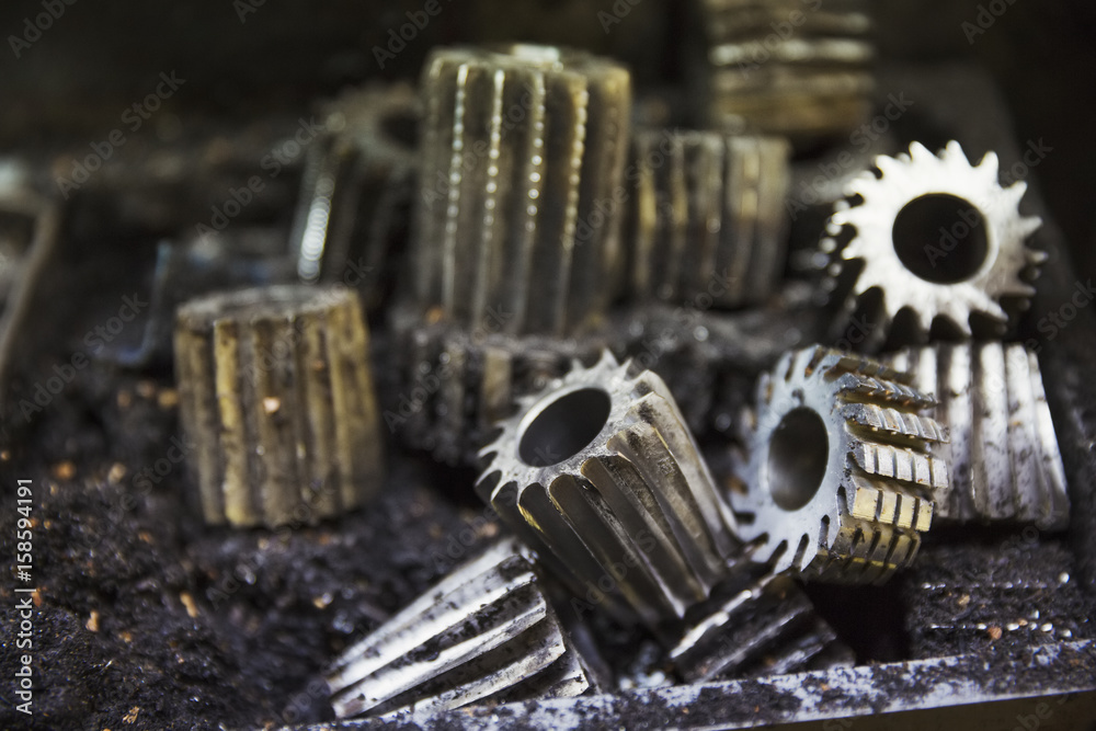 Close up of various shaped metal cogs and threads in a shoemaker's workshop. Close up of various shaped metal cogs and threads in a shoemaker's workshop.