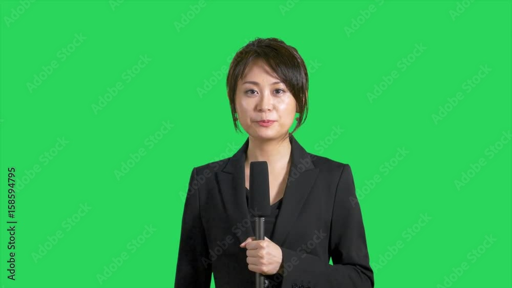 Happy Chinese Asian news reporter on green screen Happy Chinese Asian news reporter on green screen