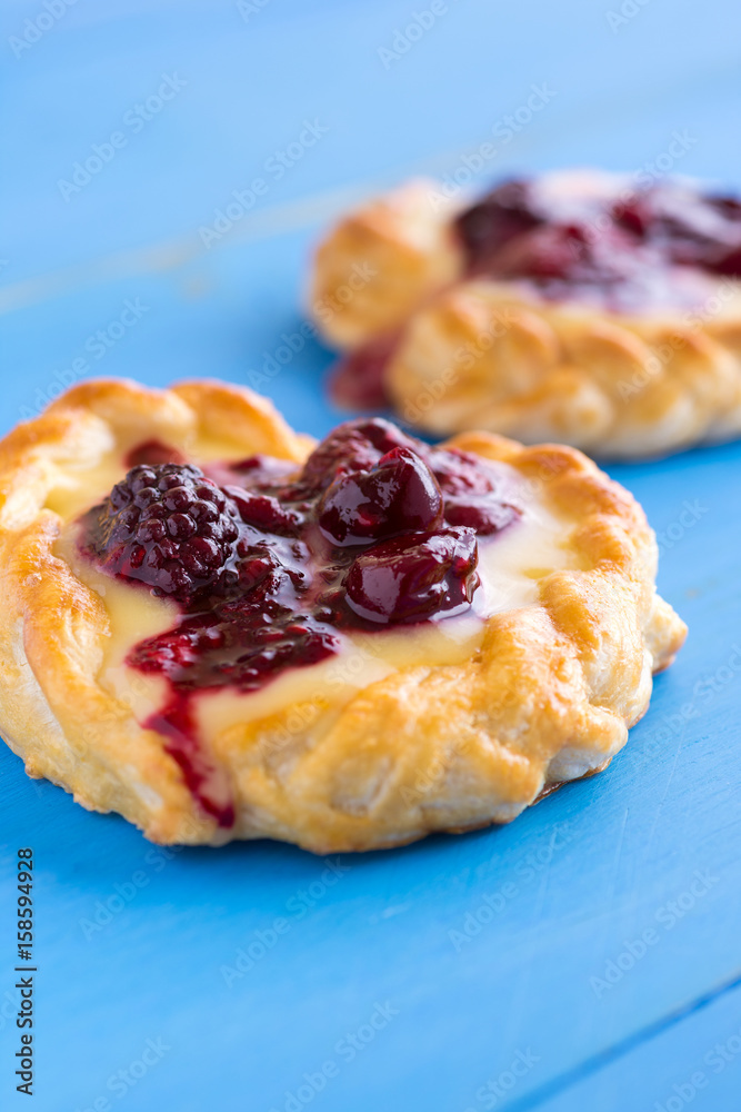 Vanilla Cream and Fruit Berry Puff Pastry Dessert on Blue Background Vanilla Cream and Fruit Berry Puff Pastry Dessert on Blue Background