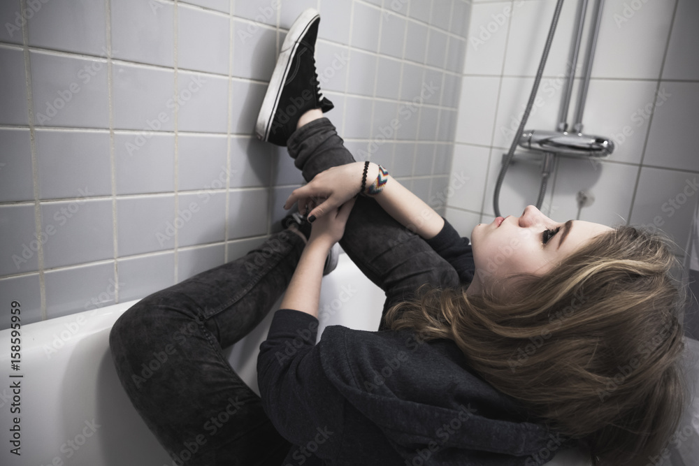 Φωτογραφία Sad Caucasian blond teenage girl in black sneakers