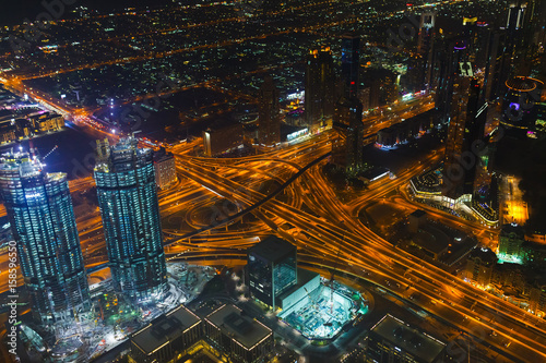 Panoramic aerial view on downtown of Dubai  UAE with modern high skyscrapers at night. Architecture of future with bright lights and roads. United Arab Emirates famous tourist destination