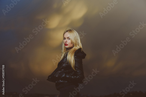pretty blonde woman with red lips in leather jacket