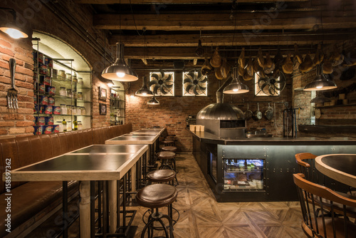 Interior of pizza restaurant with wood fired oven photo