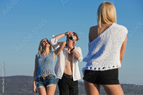 Happy friends photographing on summer vacation © Volodymyr