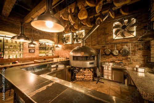Rustic pizza oven, bar and kitchen in pizzeria interior