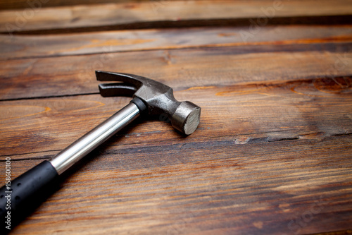 Iron hammer on wooden background. Top view Fototapet
