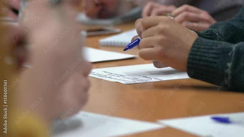 Team of young business people discuss and write their ideas
