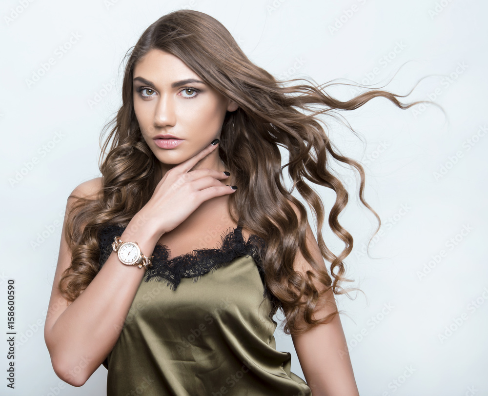 Naklejka premium beautiful young woman with long hair wearing wrist watch