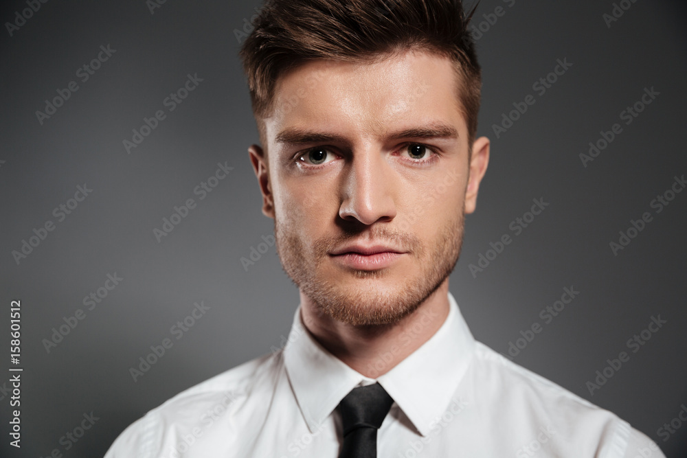Handsome elegant man in shirt and tie looking at camera Handsome elegant man in shirt and tie looking at camera