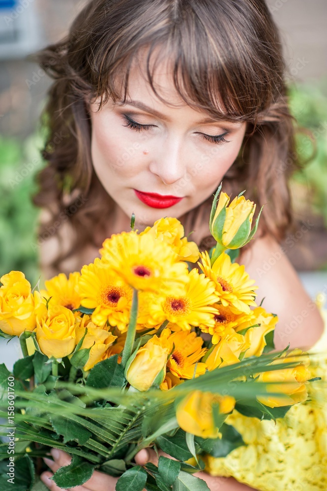 Portrait of a beautiful young woman in a yellow dress with red lipstick. Spring portrait of a girl. Portrait of a beautiful young woman in a yellow dress with red lipstick. Spring portrait of a girl.