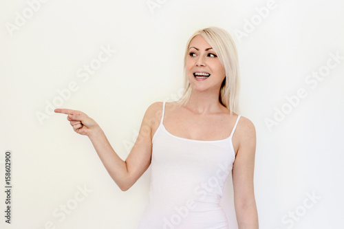 Pretty careeful woman gesturing with finger showing away
