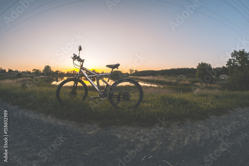 A sports bike on a dirt road in the summer evening.