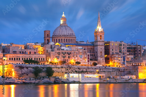 Valletta Skyline from Sliema with church of Our Lady of Mount Carmel and St. Paul's Anglican Pro-Cathedral during evening blue hour, Valletta, Capital city of Malta © Kavalenkava