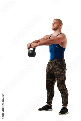 Young sporty man in sportswear doing exercise with weight, hands in raised position on white isolated background