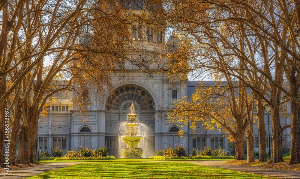 A row of trees leading to a fountain in front of the royal exhibition building at Carlton Gardens in Melbourne, Australia. A row of trees leading to a fountain in front of the royal exhibition building at Carlton Gardens in Melbourne, Australia.