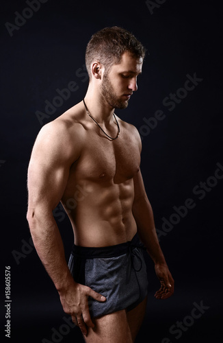 Young bodybuilder on a black background