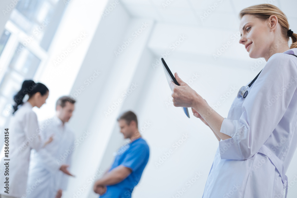 Curious doctor testing new digital gadget in the clinic Curious doctor testing new digital gadget in the clinic