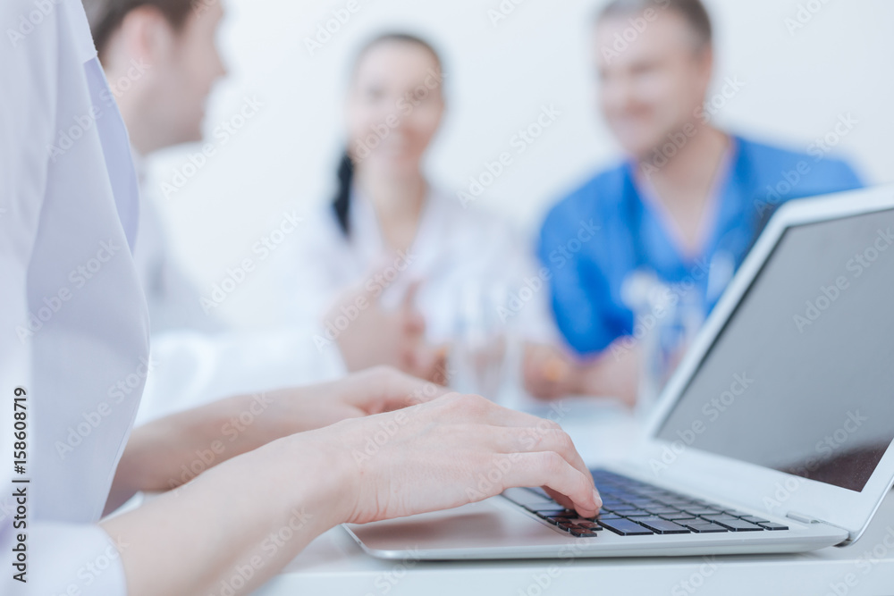 Skillful medical specialist using digital gadget at work Skillful medical specialist using digital gadget at work