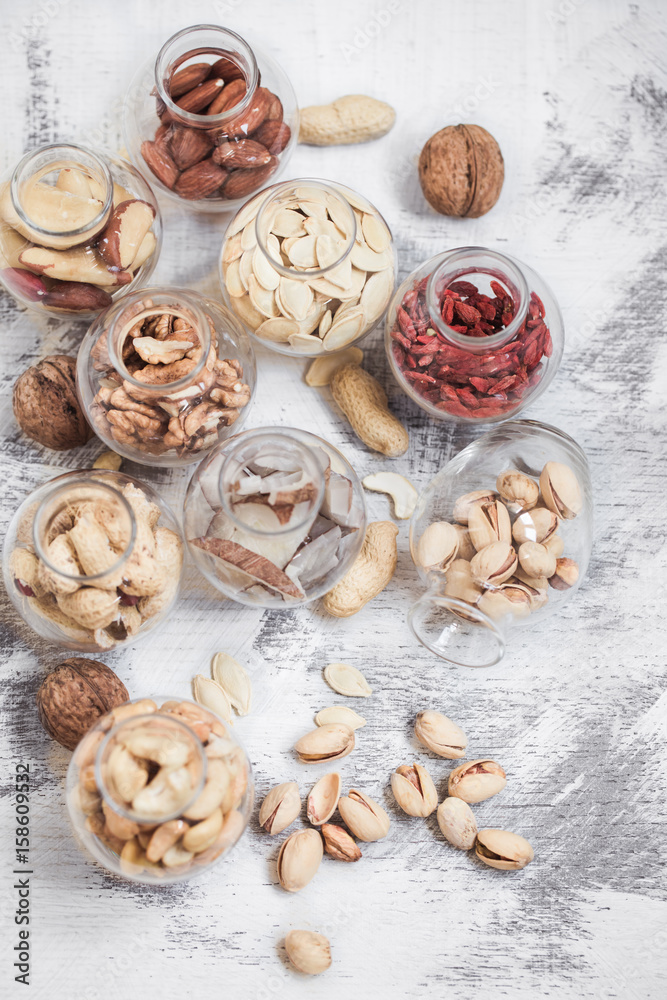 Fototapeta premium Different nuts in jars