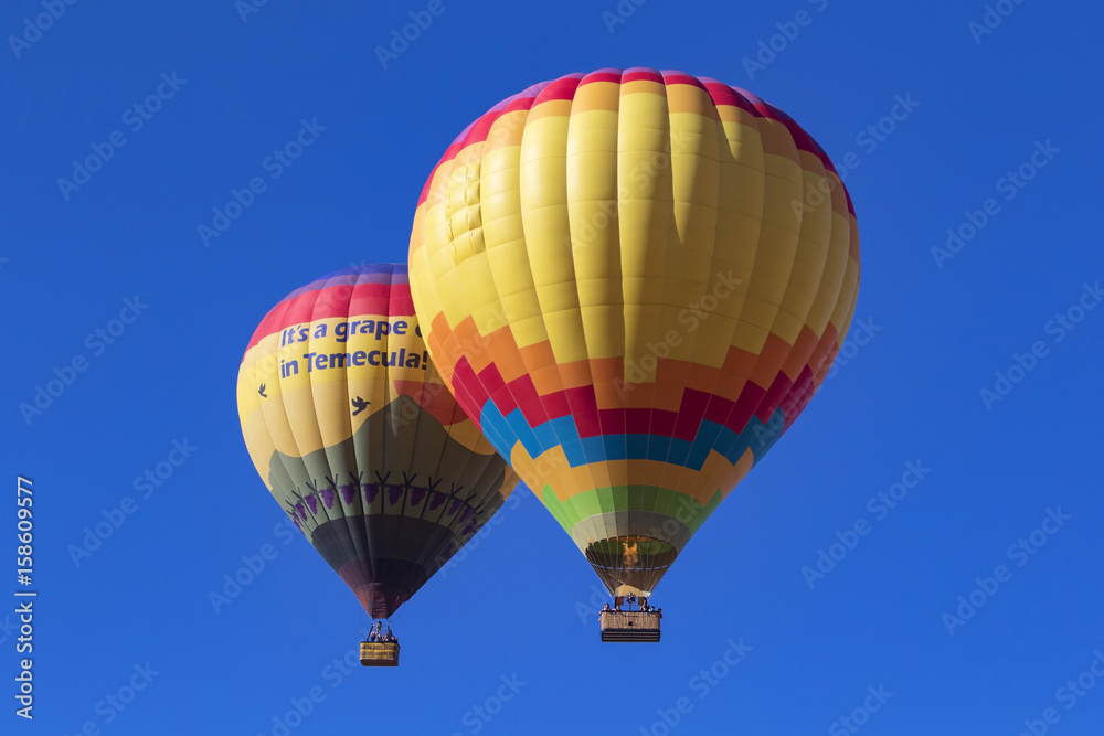 Obraz premium Balloons floating together over Southern California winery and vineyards