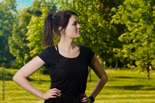 The athletic atleth woman does exercises in the city park. Fitness training outdoors. Workout outdoors. Healthy lifestyle
