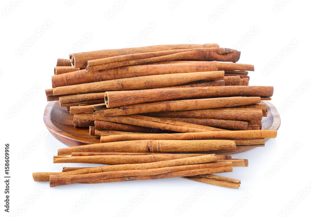 Cinnamon in plate on white background