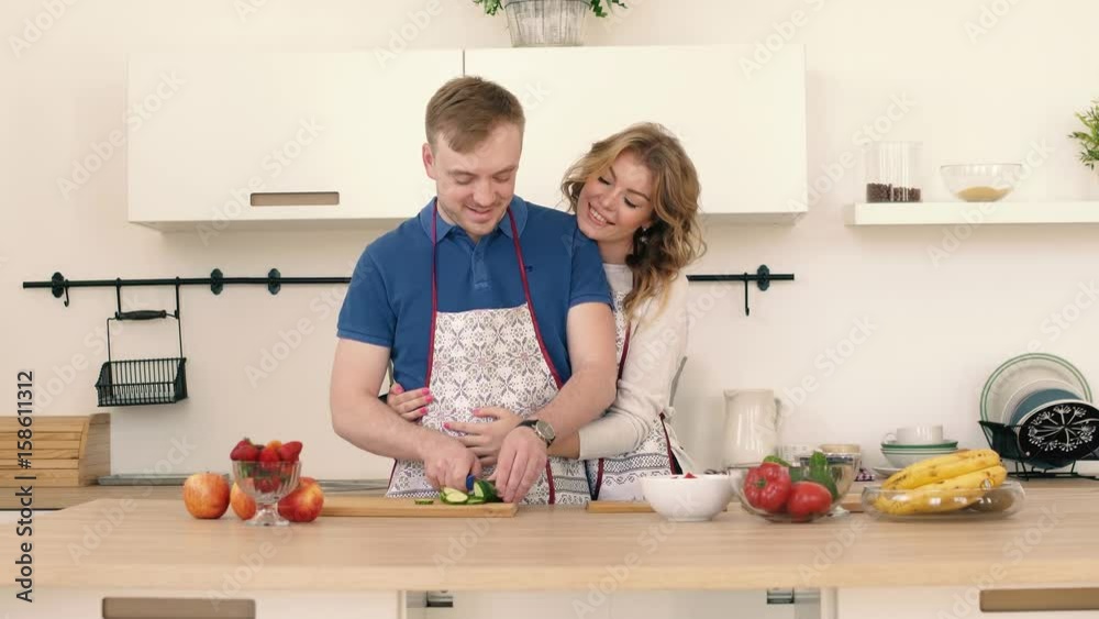 Portraits of a couple in love who prepare a salad in the kitchen. Portraits of a couple in love who prepare a salad in the kitchen.