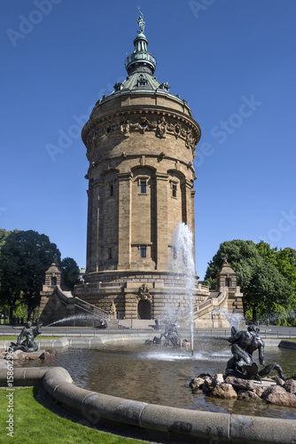 Germany, Baden-Wuerttemberg, Mannheim, near Planken: Water Tower on Friedrichsplatz square with fountain and blue sky in the background