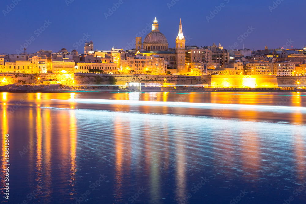 Valletta Skyline from Sliema with church of Our Lady of Mount Carmel and St. Paul's Anglican Pro-Cathedral during evening blue hour, Valletta, Capital city of Malta