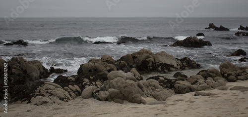 Ocean waves hitting stones on the shore