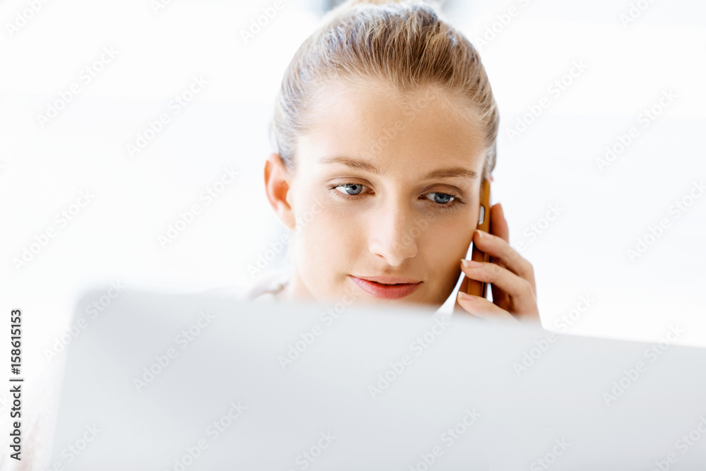 Attractive office worker sitting at desk