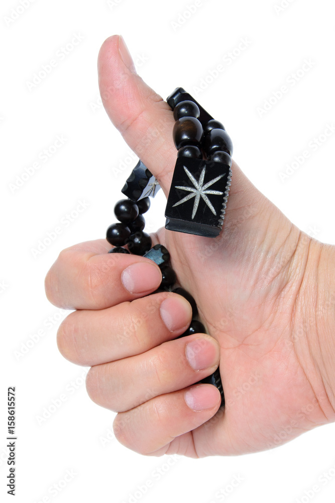 Rosary in hand on a white background isolated