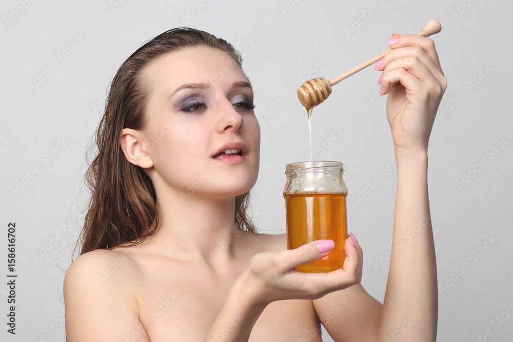 Fototapeta premium Beautiful woman with honey on her face