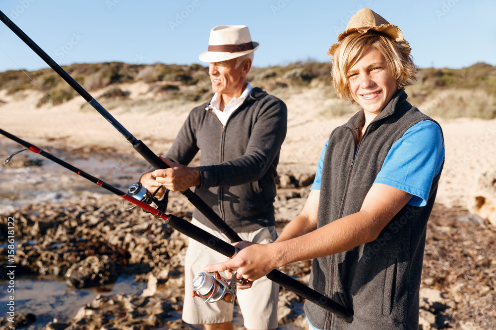 Senior man fishing with his grandson Senior man fishing with his grandson