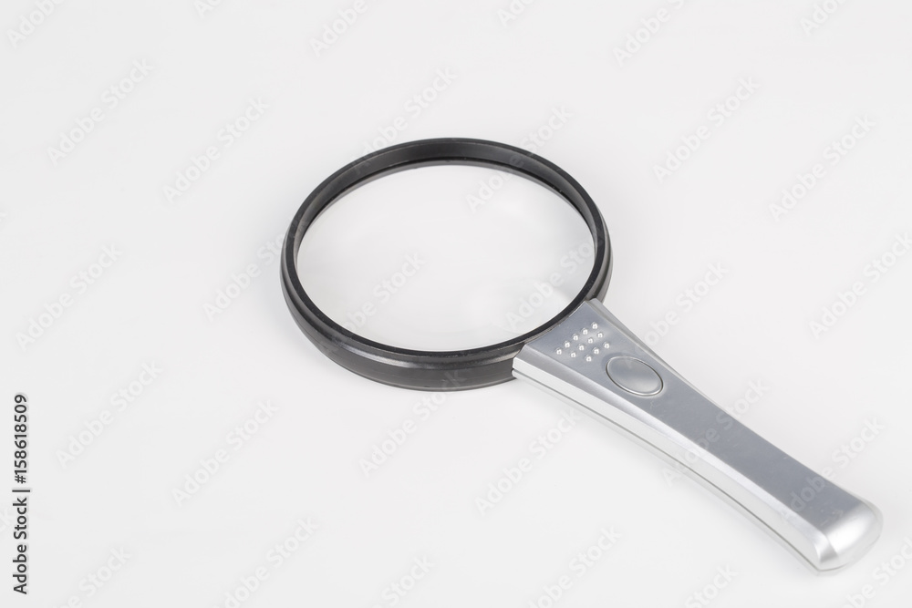 One modern magnifying glass on white bakground. One modern magnifying glass on white bakground.