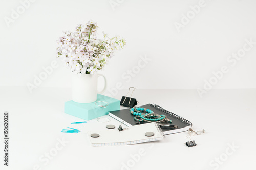 Feminine styled office desktop with teal accents photo