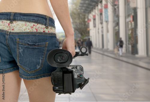 cameraman girl holding his professional camcorder in the street © Philipimage