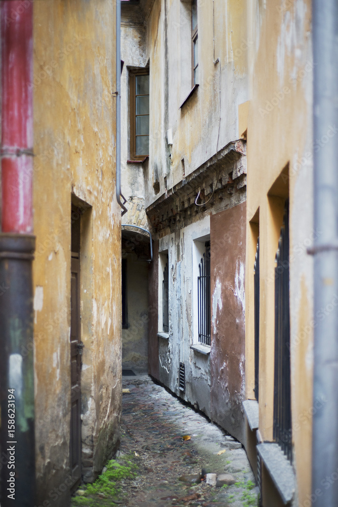 very narrow and dirty alley in the old town. The narrowest street in Vilnius, Lithuania