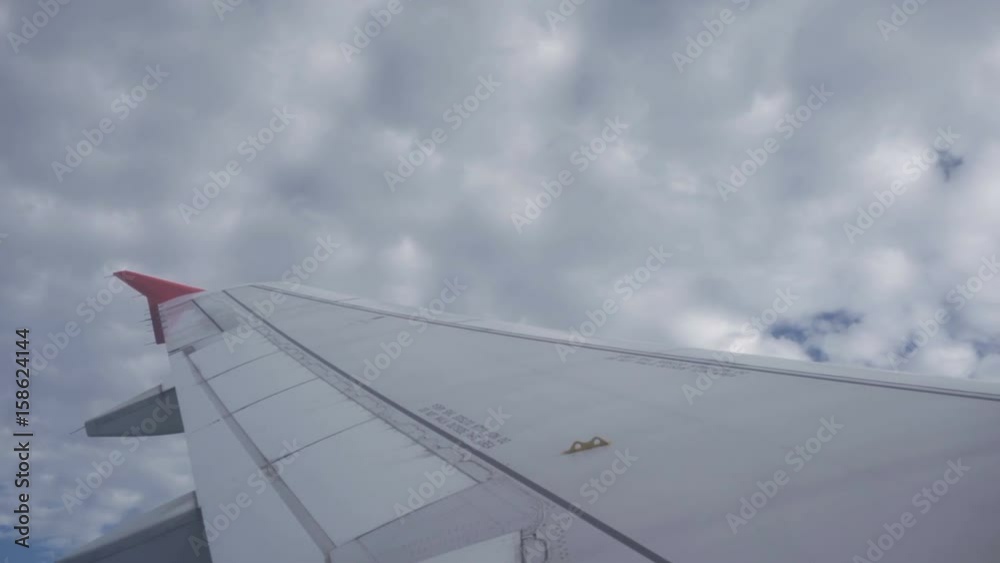 View through an airplane window on the sky and clouds. Aerial view Clouds and sky as seen through window of an aircraft. 4K video. Aerial footage. Travel concept. View through an airplane window on the sky and clouds. Aerial view Clouds and sky as seen through window of an aircraft. 4K video. Aerial footage. Travel concept.