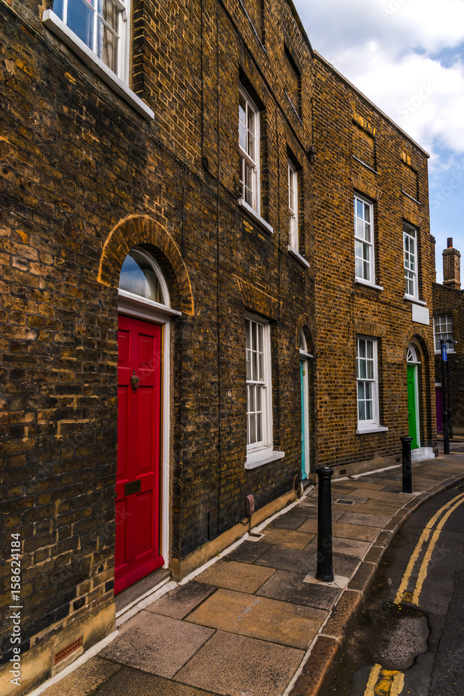Typical old English buildings, low brick buildings across a narrow street, interesting old London architecture