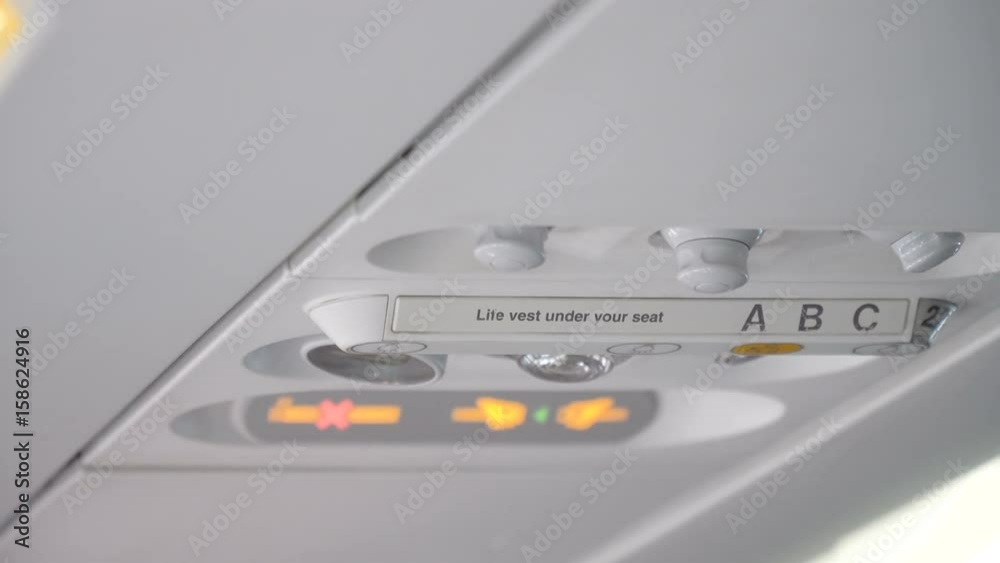 Signs on an airplane.The fasten seatbelt light has come on. Please take your seats. These the are no smoking and seat belt. 4K video. Travel concept. Signs on an airplane.The fasten seatbelt light has come on. Please take your seats. These the are no smoking and seat belt. 4K video. Travel concept.