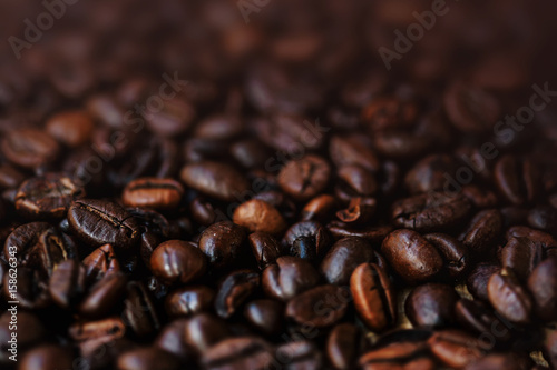 Dark Roasted Coffee Beans Espresso wallpaper with brown colored copyspace close up. Fried Coffee Beans Texture macro © nataliazakharova